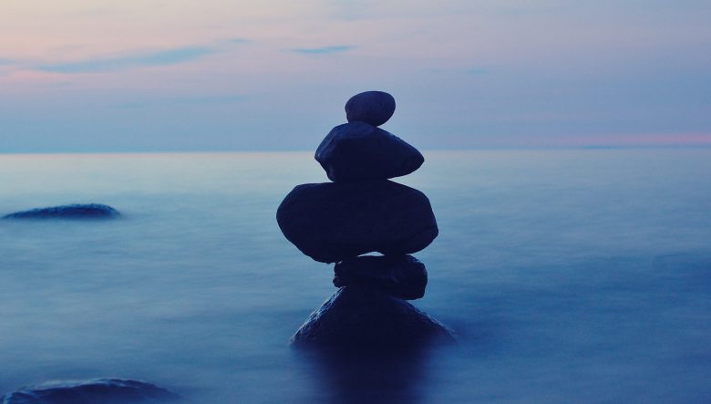 balance rocks stacked in the water - yoga