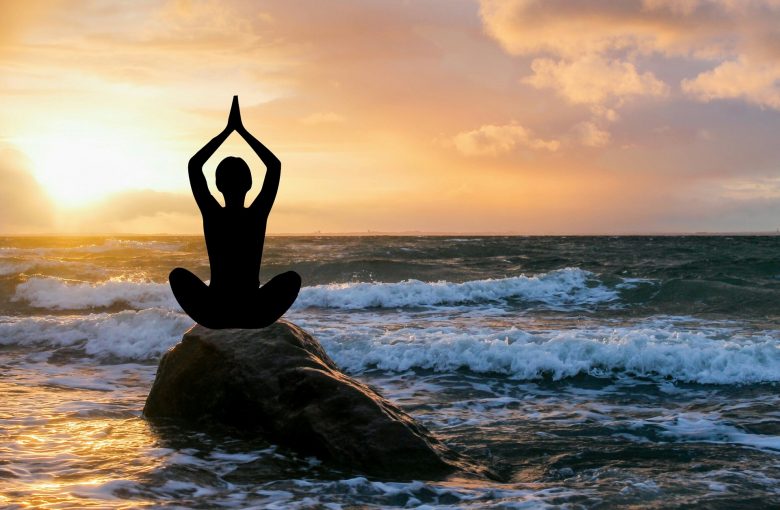 meditation on a rock by the sea