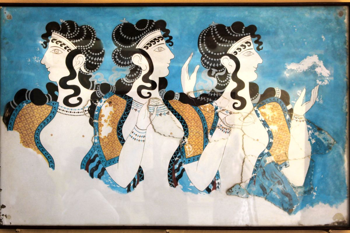 A vibrant Minoan fresco depicting three women in profile, adorned with intricate hairstyles and colorful garments, showcasing the artistry of ancient Crete.